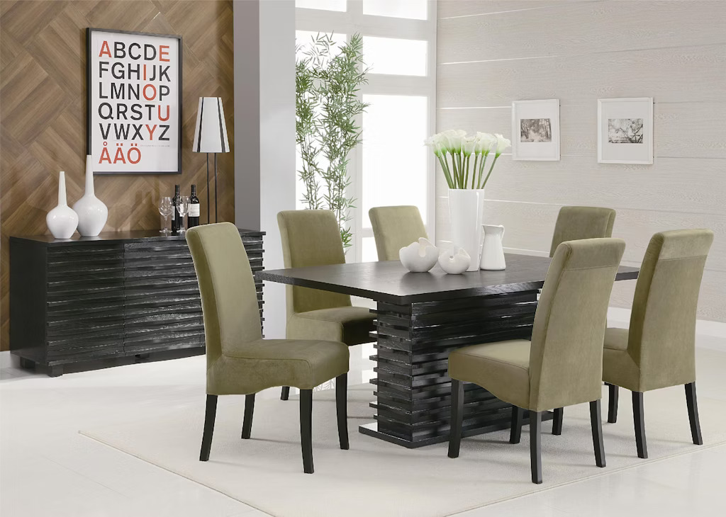 Coaster Casual Dining Stanton Rectangular 66-inch Dining Table in Black (102061) at Payless Furniture, featuring a modern black wood table with a slatted base, complemented by six olive-green upholstered chairs in a contemporary dining room setting. The space includes a sideboard, minimalist decor, and natural lighting.